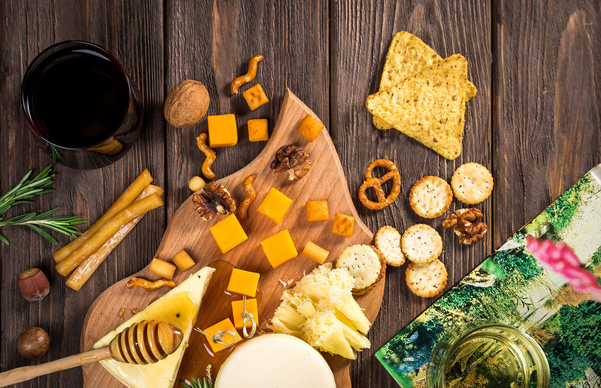 A cheese platter with scattered trail mix.