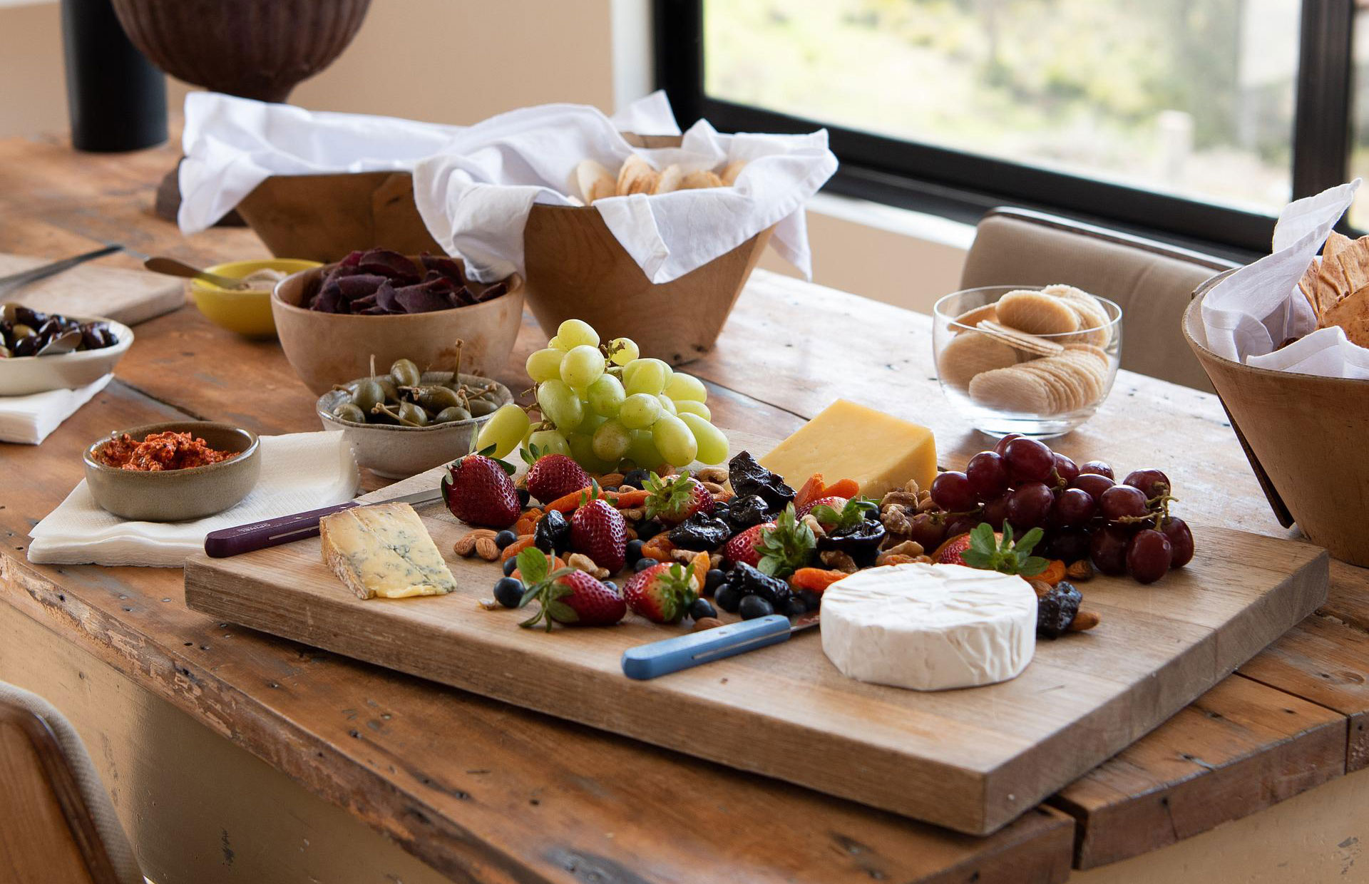 A Chacuterie board of cheese and grapes.